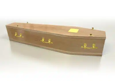 Classic light polished wood coffin with brass handles and traditional fittings