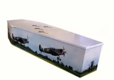 Bespoke coffin featuring Spitfire aircraft design with sky and landscape background